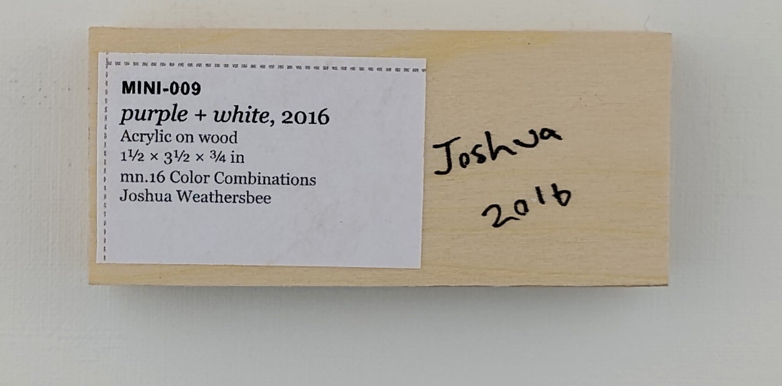 Back of purple + white, showing signature and label
