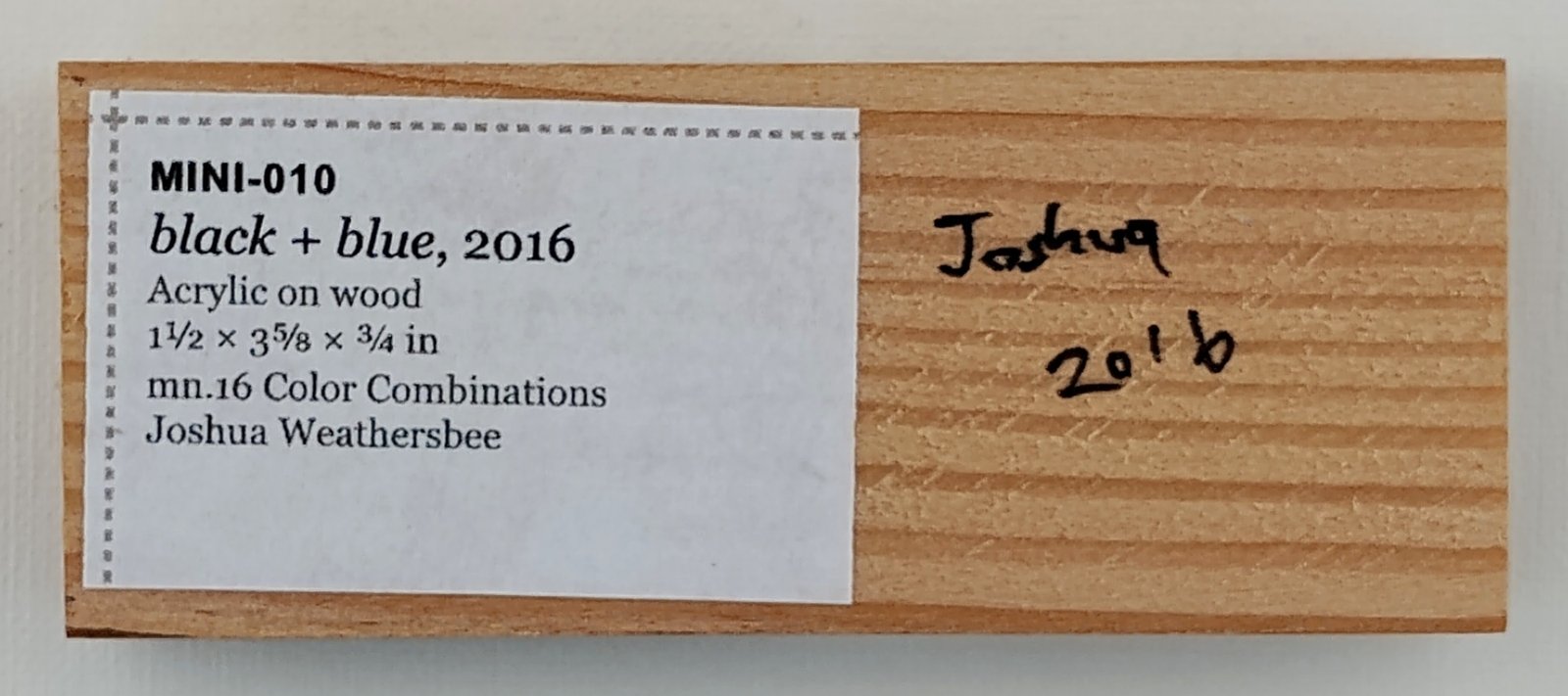Back of black + blue, showing signature and label