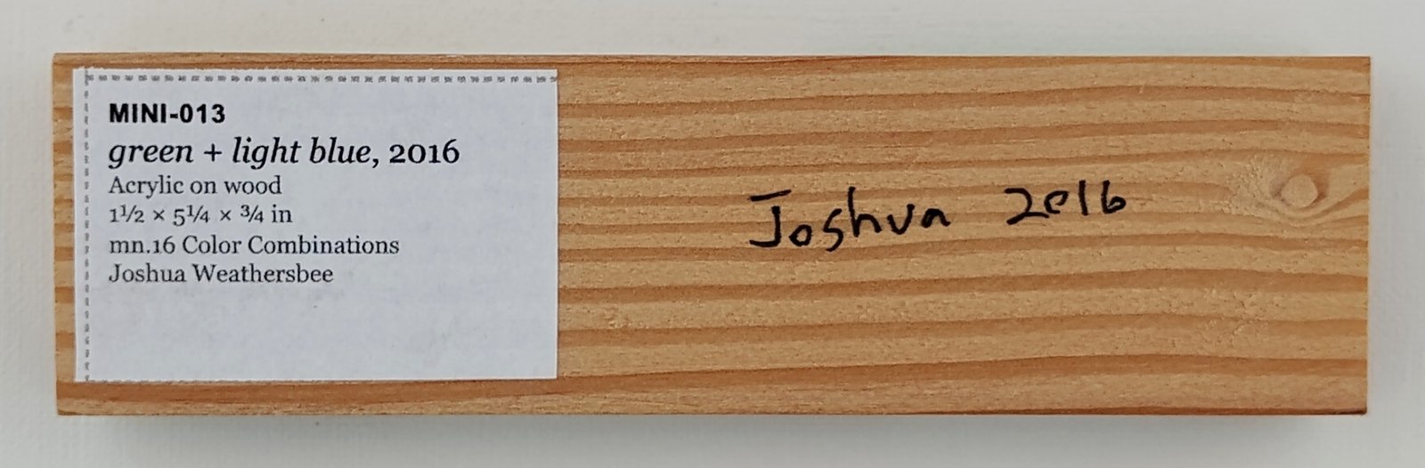 Back of green + light blue, showing signature and label