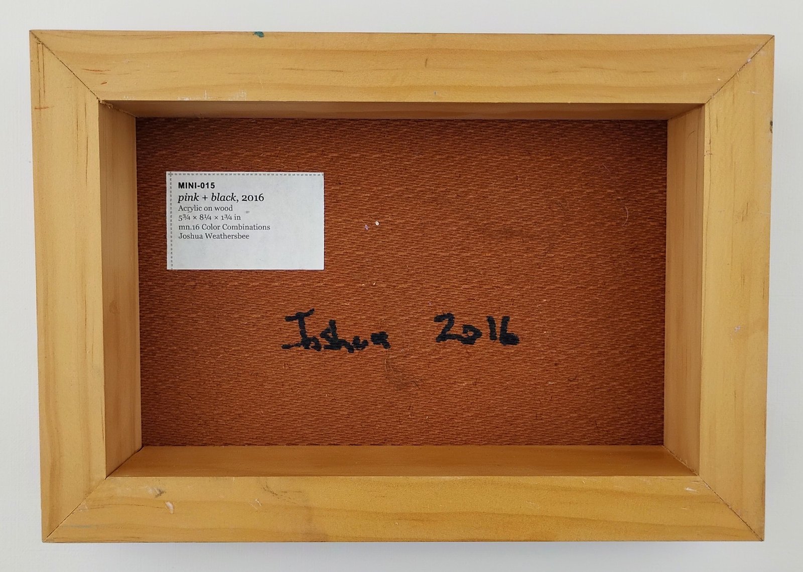 Back of pink + black, showing signature and label